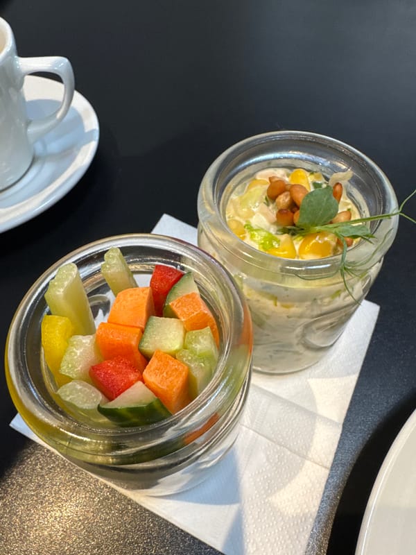 Two food jars photographed on napkin with cup visible