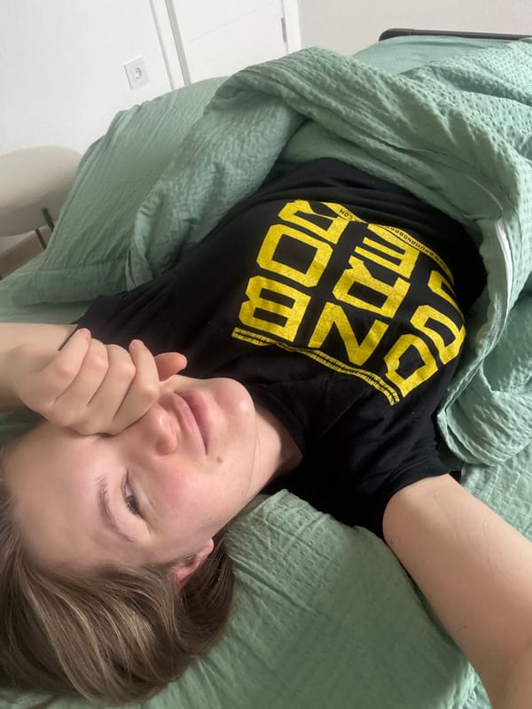 Person resting in bed covers face in Belgrade suburb