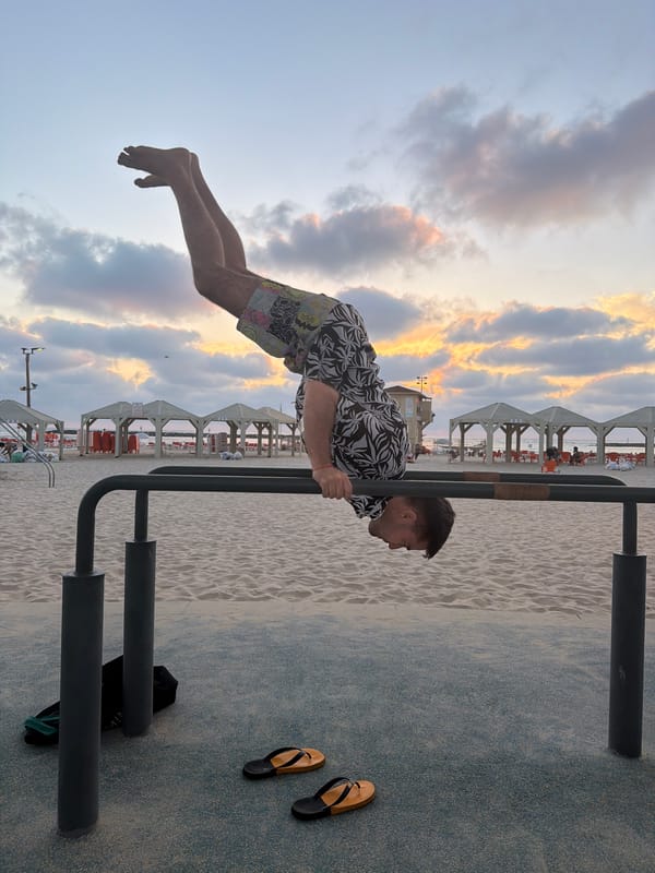 Man performs human flag exercise on Tel Aviv beach bars