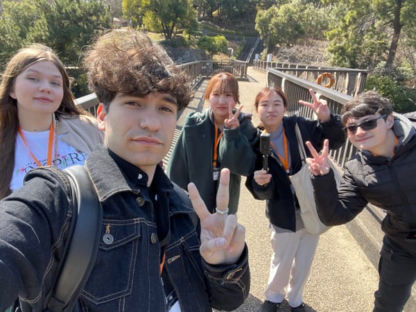 Young visitors photograph Great Buddha statue at Tokai park
