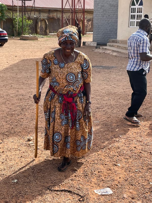 Woman with papers gathers with crowd in Jos, Nigeria