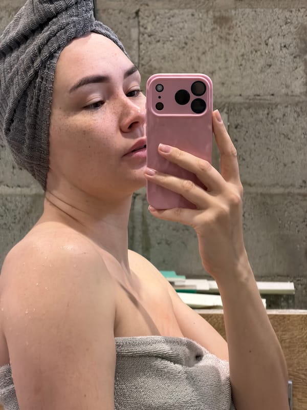 Woman takes post-bath selfies in Russian apartment window