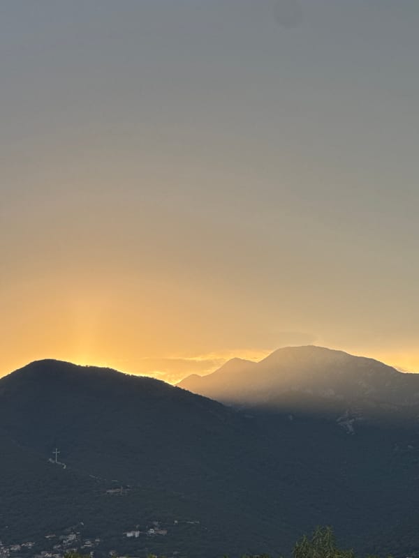 Mountain bay at golden hour, from shoreline to sailboats