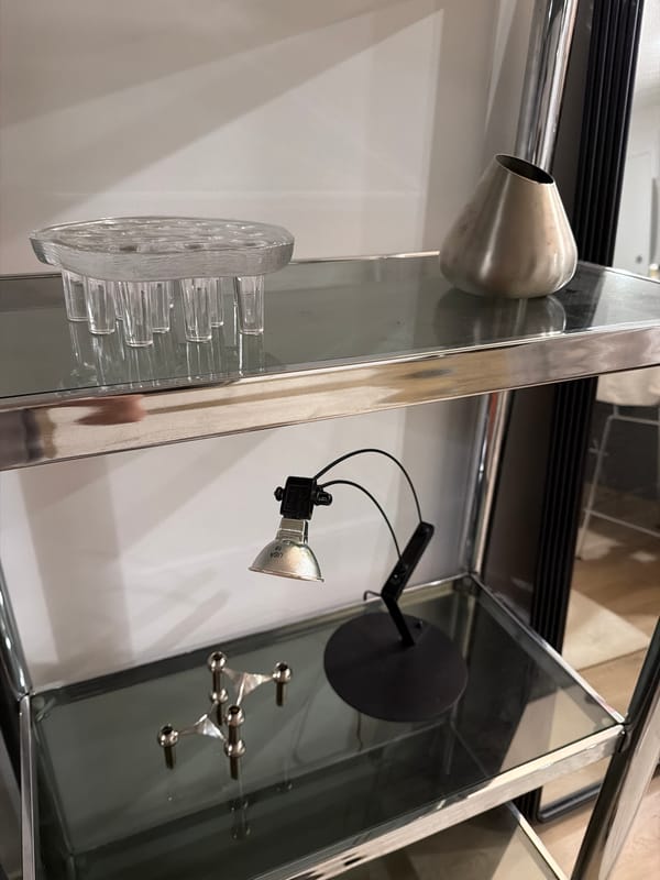 Metallic decorative objects spotted on glass shelving in Laval