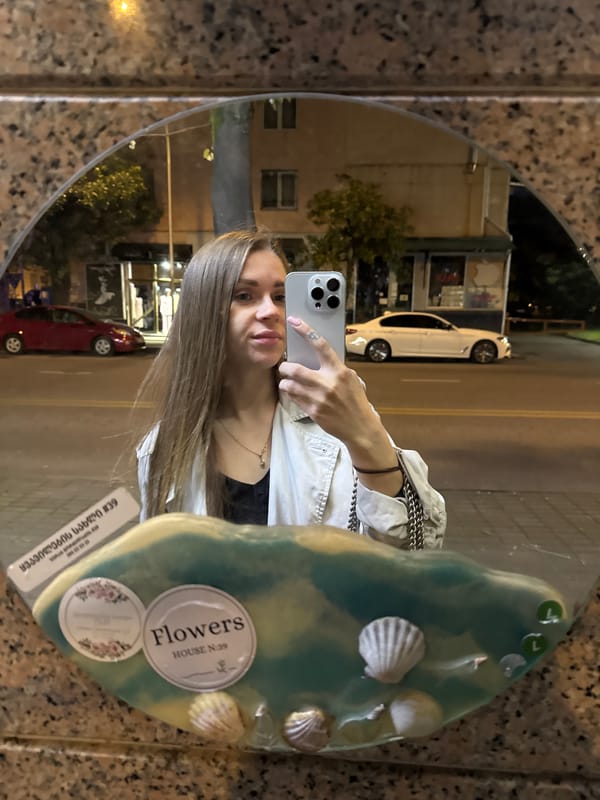 Woman takes nighttime selfie on busy Batumi street