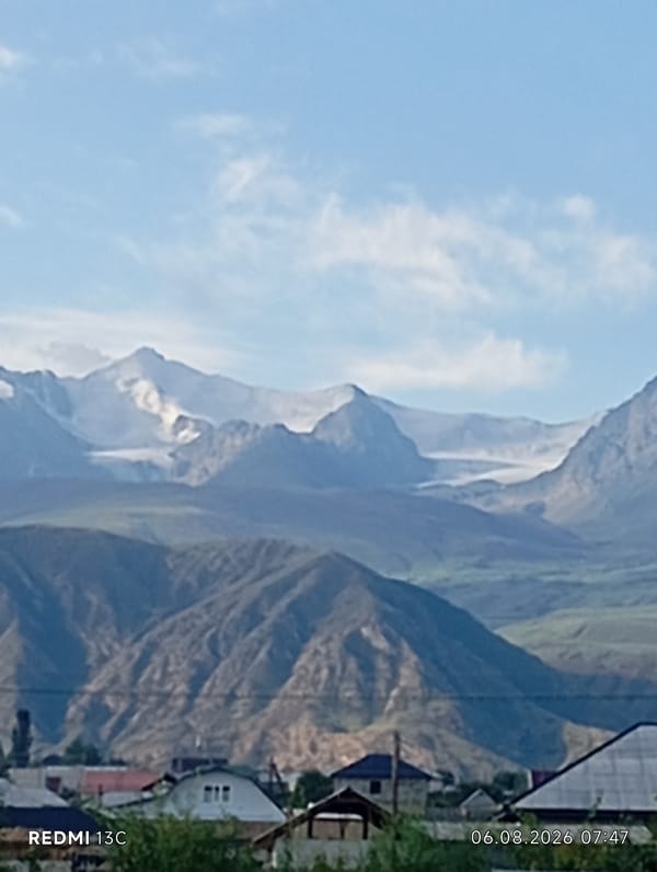 Mountain views and windowsill flowers in Bökönbaev, Kyrgyzstan