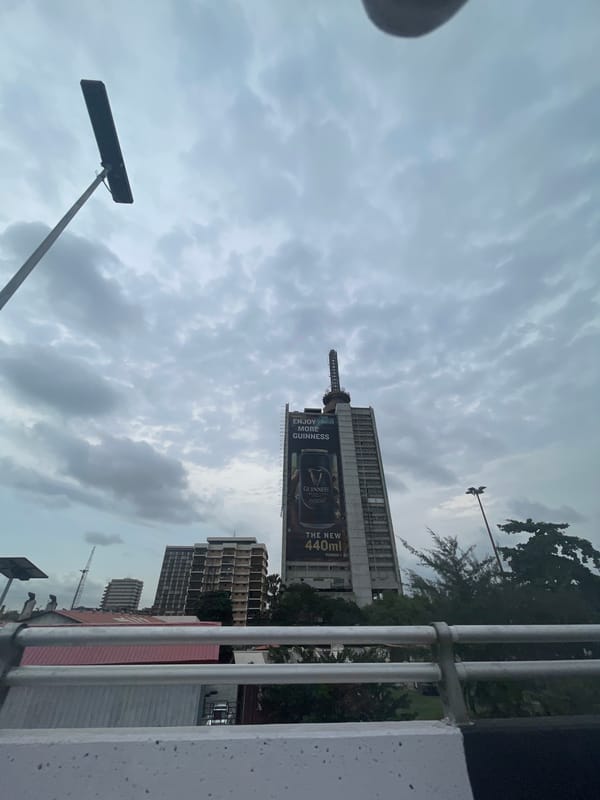 Cloudy morning skies documented over Lagos cityscape with Guinness billboard