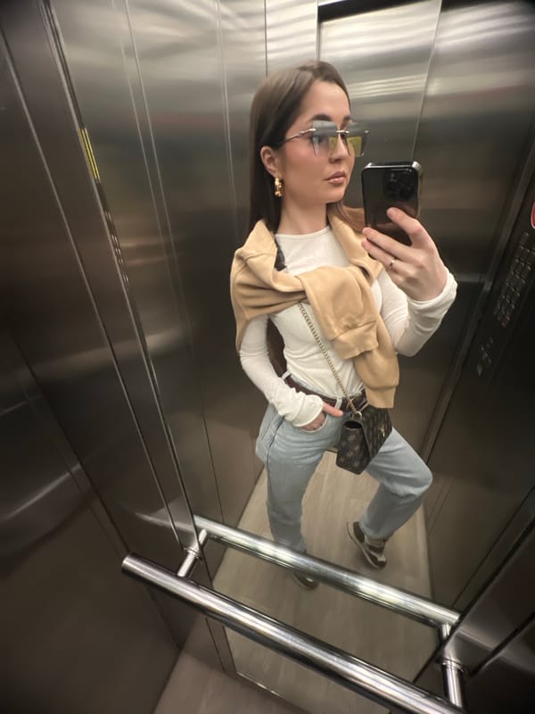 Woman Takes Selfie in Stainless Steel Elevator
