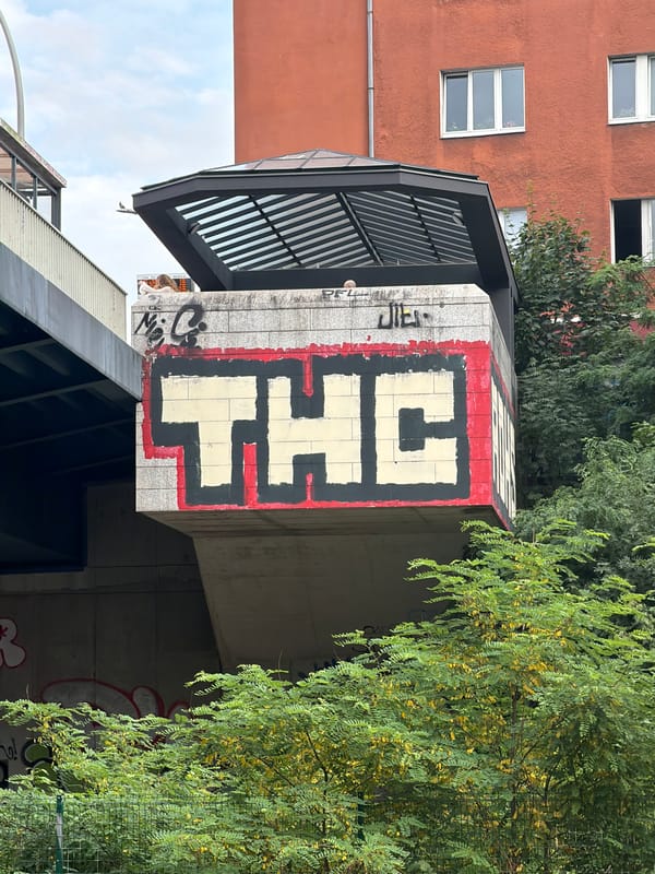 Berlin train platform, graffiti walls, yellow-red train arriving