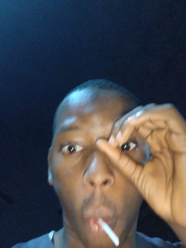 Person with lollipop documented on Lagos street at night