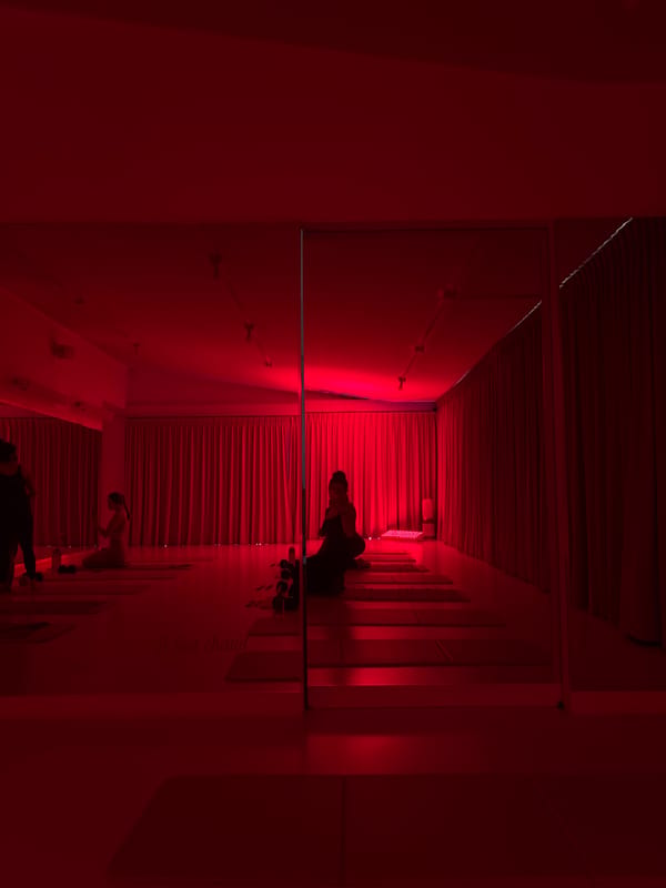 Hot yoga class documented in red-lit Mexico City studio