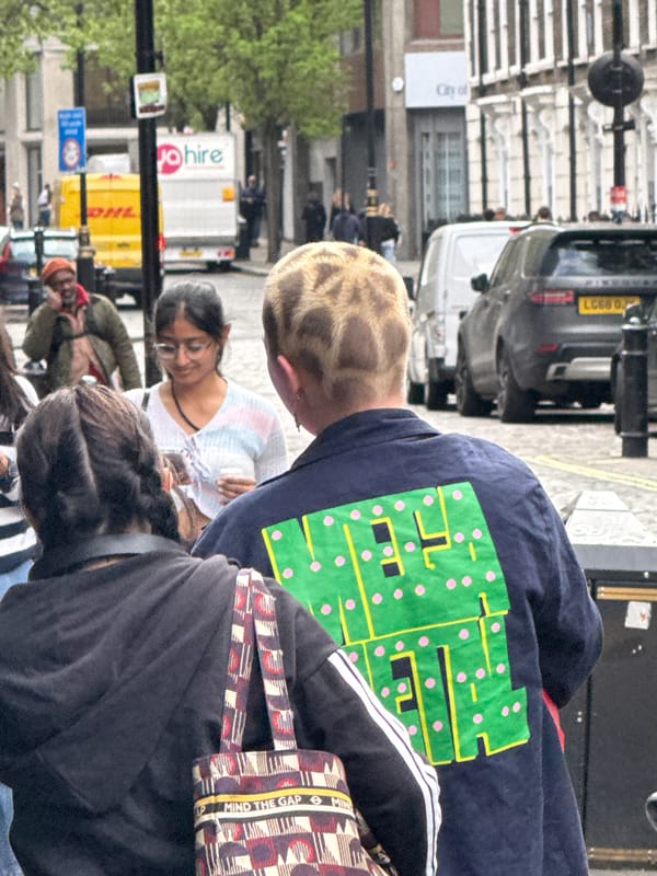 Person in circuit board shirt spotted among group in London