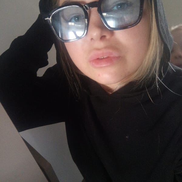 Person in black hoodie photographed in close-up shots