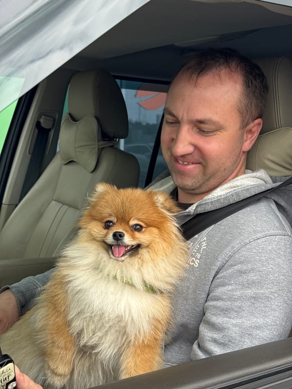 Man with Pomeranian dog visits cafe area in Medovoye, Russia