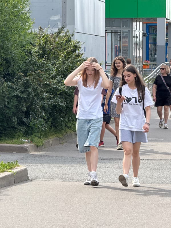 Casual street stroll along a Saint Petersburg sidewalk in summer.