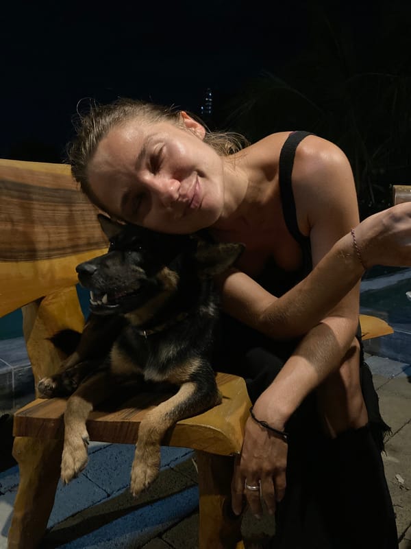 Woman with German Shepherd captured indoors at night in Mũi Né
