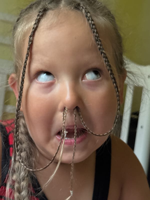 Overhead close-up of braided hair and upward gaze, Russia