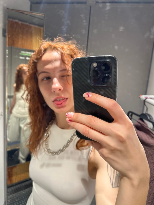 Woman photographs herself near Aleksandar Tišma mural in Novi Sad