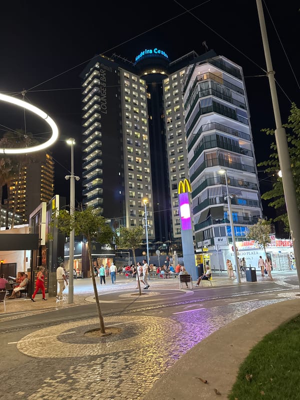 Benidorm promenade at night: arcades, lights, and street life