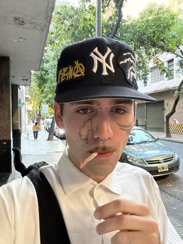 Tattooed youth spotted smoking in Buenos Aires wearing Yankees cap