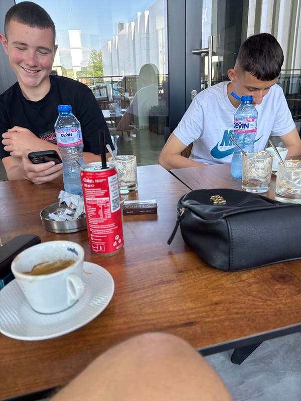 Young men dining at outdoor cafe in Kardzhali, Bulgaria