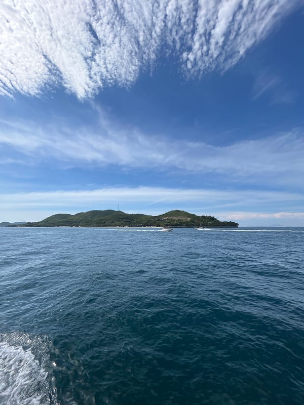 Motorboat crossing open water off Nha Trang's island coastline