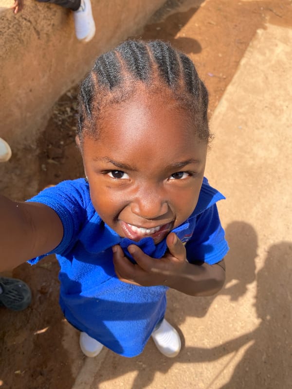 Nigerian schoolchildren pose for photos during playground time