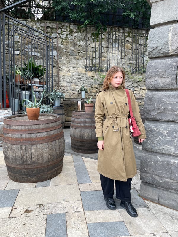 Woman in trench coat photographed on Tbilisi street
