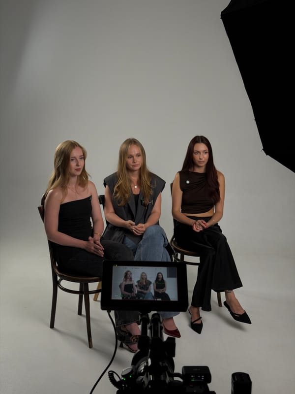 Studio interview setup with three seated subjects, Krasnoyarsk