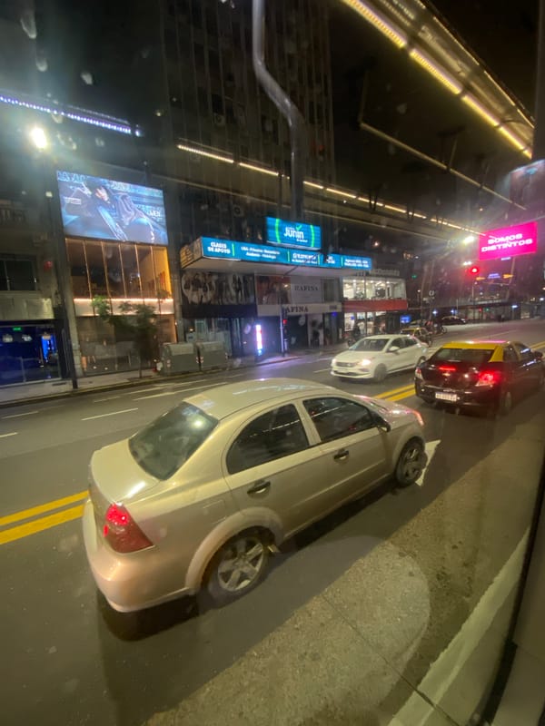 Nighttime street scene captured in Buenos Aires with McDonald's visible