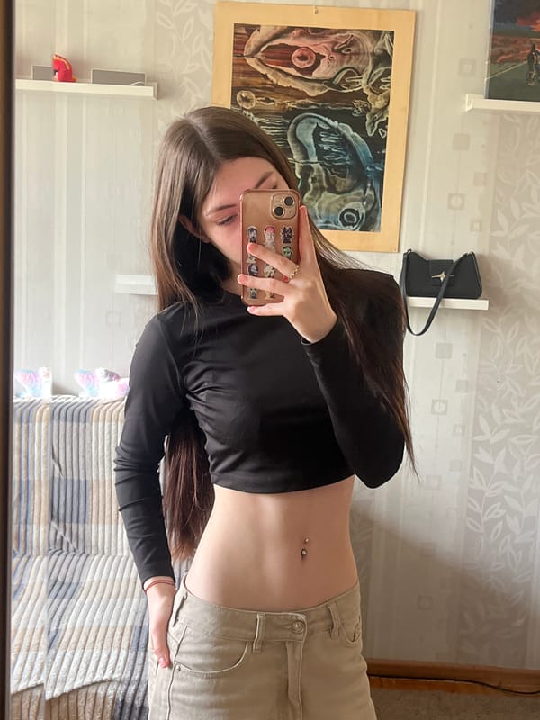 Young woman documents casual selfie session in Russian home