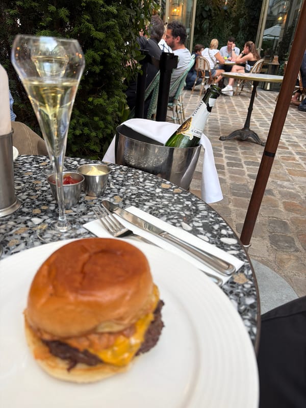 Diner enjoys burger and champagne at Paris restaurant