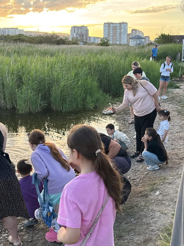 Golden hour waterfront gathering documented in Novorossiysk, Russia