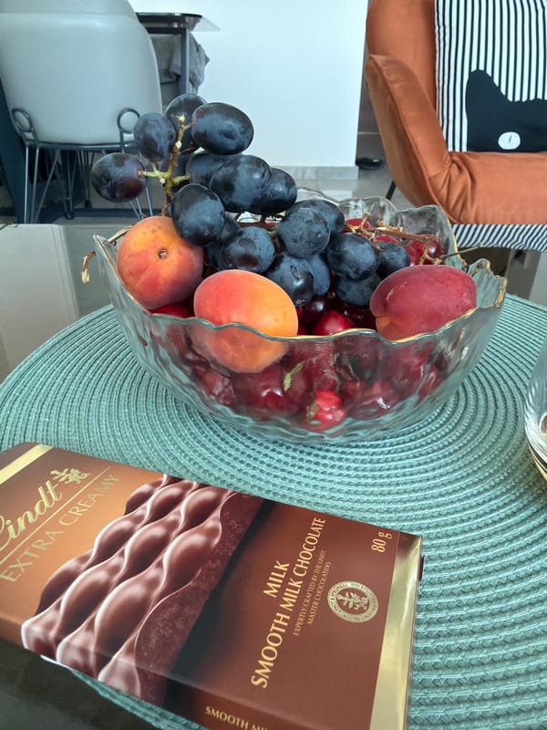 Fruit bowl and city views from a balcony setup