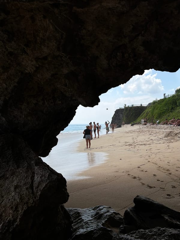 Cave-framed beach views along Kuta Selatan's rocky coastline