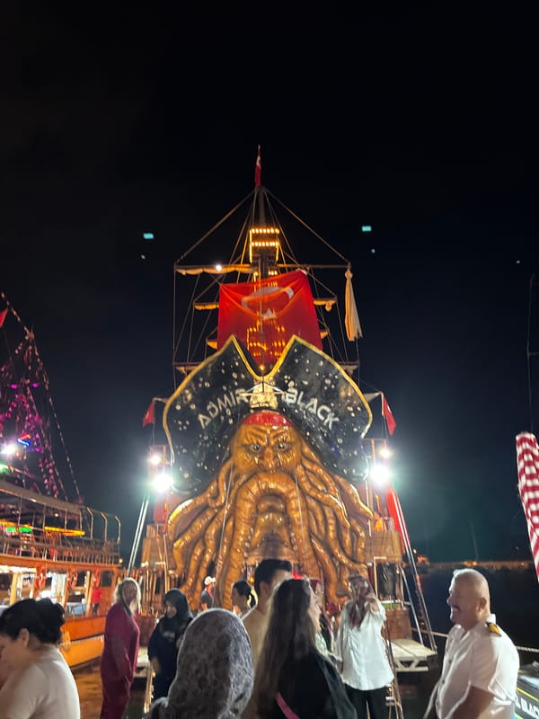 Alanya's neon-lit pirate boat harbor at night