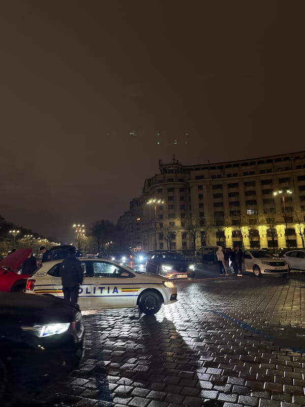 Police patrol wet streets near Palace of Parliament, Bucharest