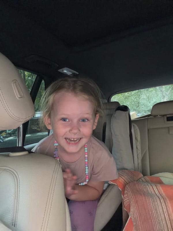 Girl and parrot share car ride in Moscow