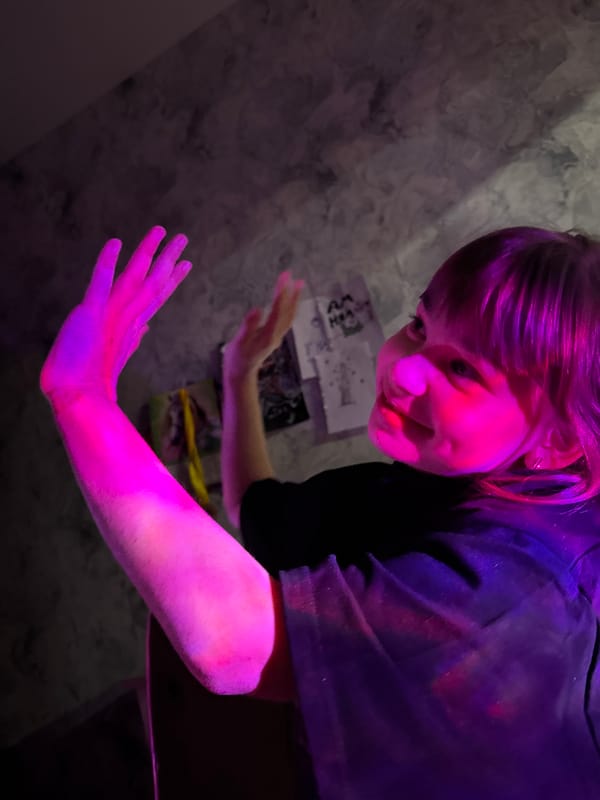 Person spotted under surreal pink-purple lighting in Rusanovo