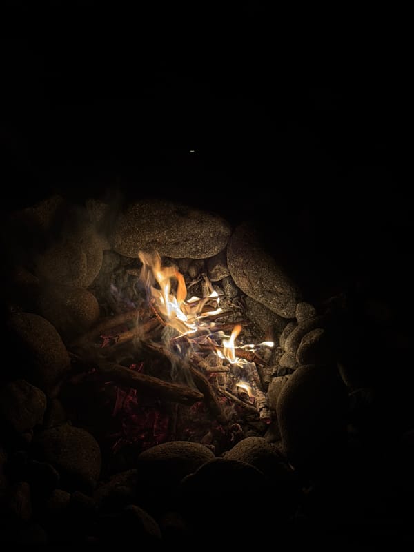Campfire night on a rocky coastal shoreline