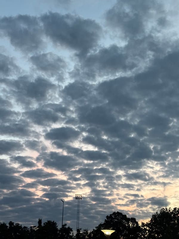 Heavy cloud cover breaks with faint light over Søborg