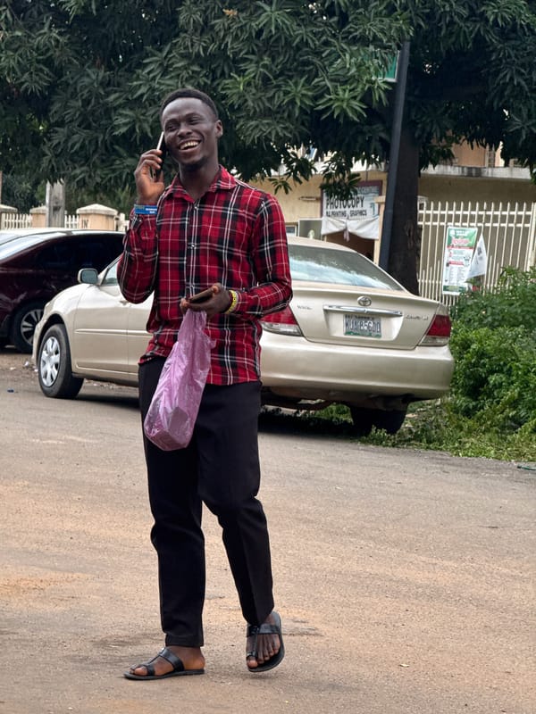 Street life near an Abuja transport hub, mid-morning