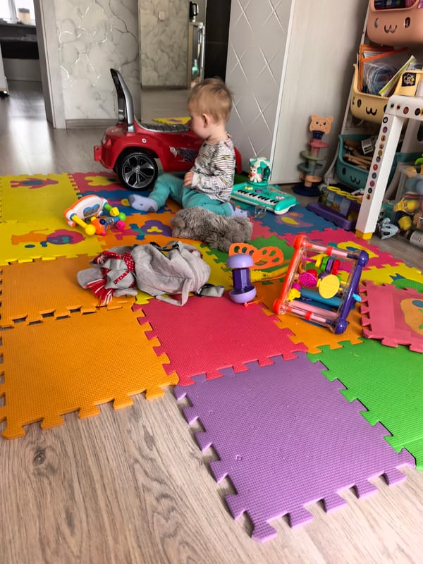 Toddler plays indoors during early morning hours in Sterlitamak