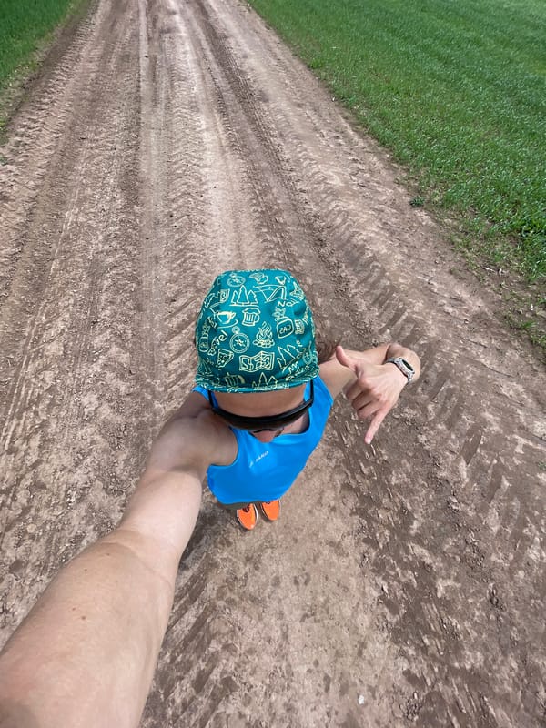 Man takes selfies on rural dirt road under cloudy sky