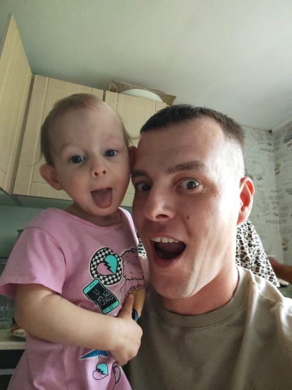 Father and child share playful moment in Russian home