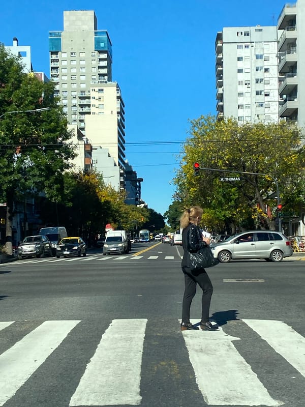 Woman crosses street on crosswalk in Buenos Aires