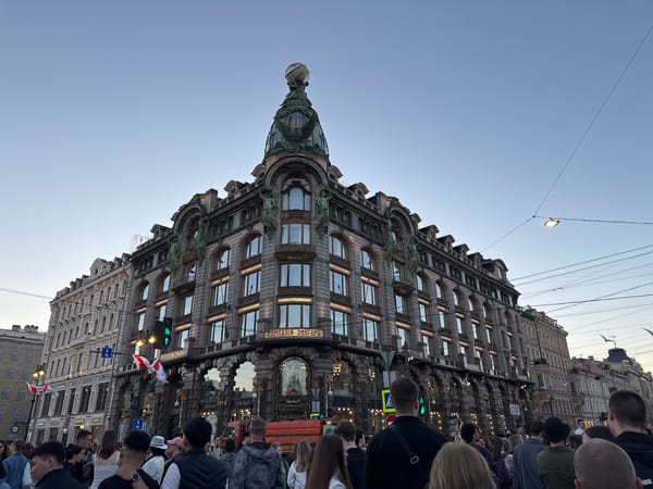 Summer evening crowds fill Nevsky Prospekt around Kazan Cathedral