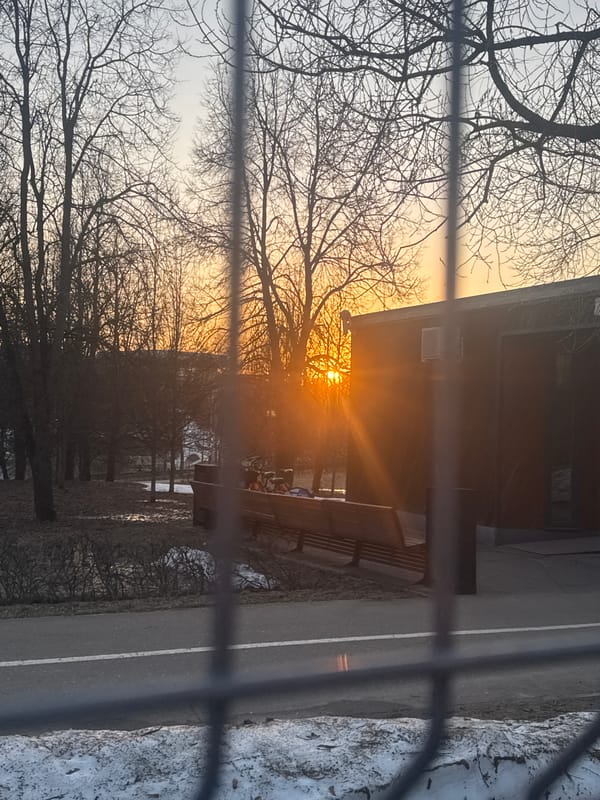Late afternoon sun illuminates Moscow cityscape through window