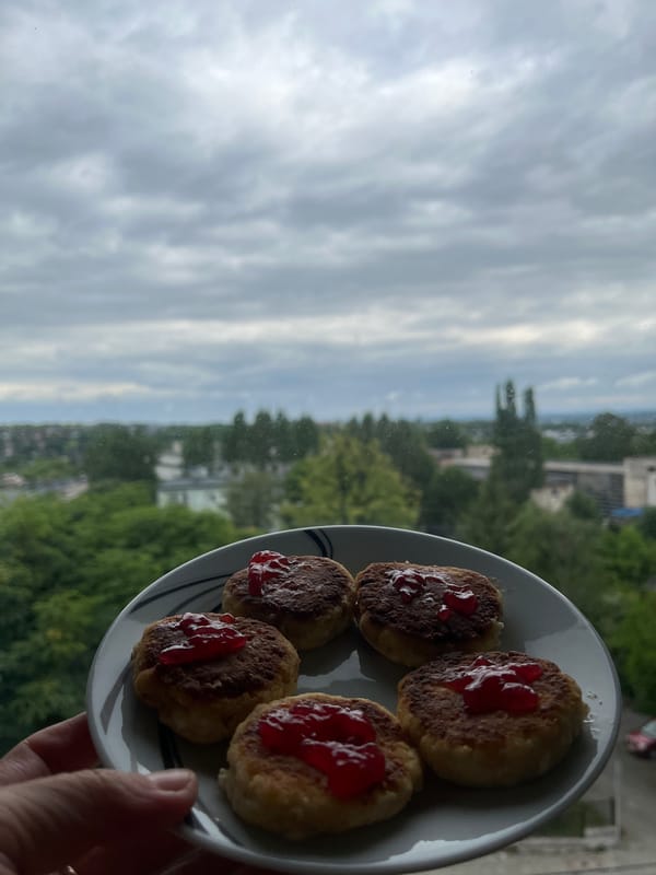 Breakfast with syrniki and coffee overlooking city skyline