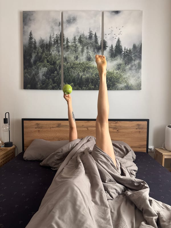 Person resting in bedroom with forest artwork in Chaikovsky